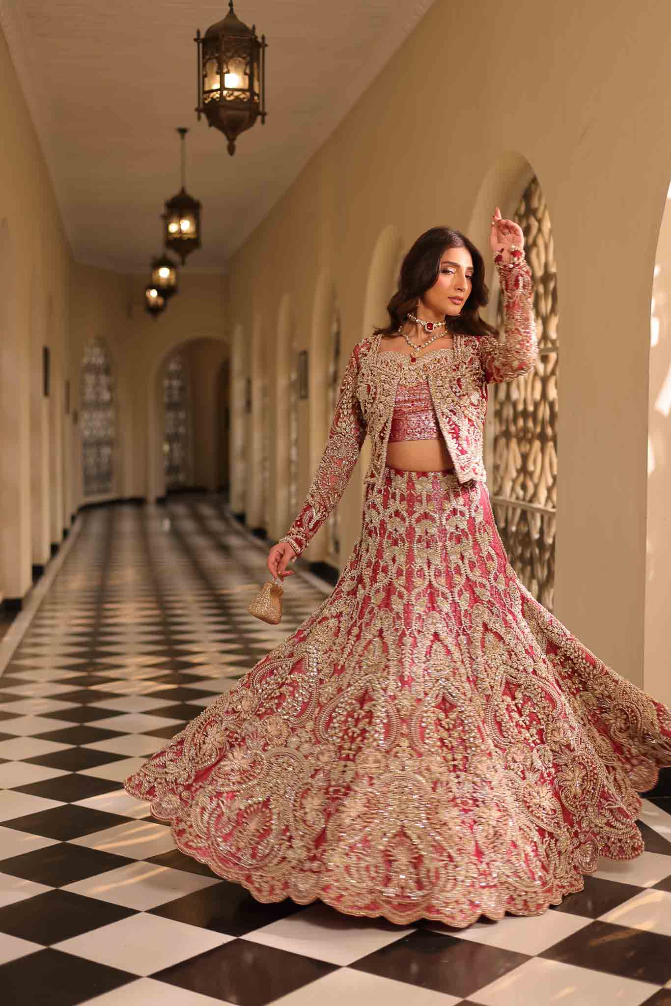Model wearing deep red and gold bridal gown AURAA from Mysie by Tahira, Pakistani luxury pret available online in UK for weddings.