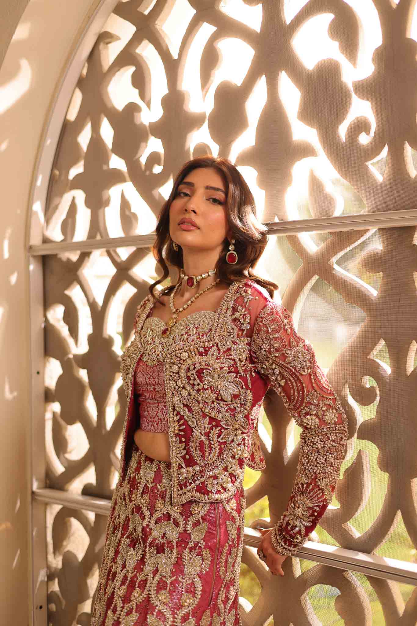 Model wearing deep red and gold bridal gown AURAA from Mysie by Tahira, Pakistani luxury pret available online in UK for weddings.