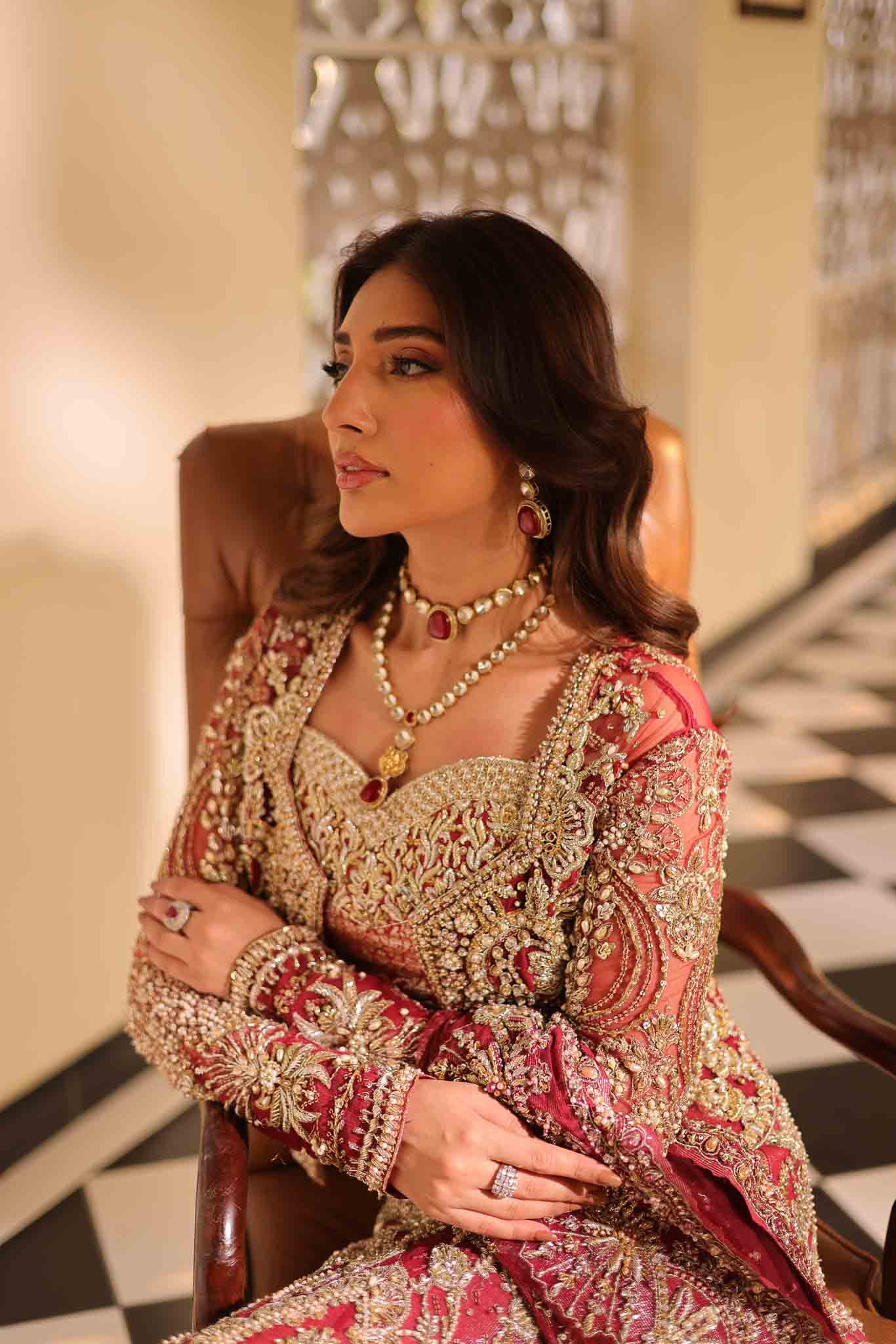 Model wearing deep red and gold bridal gown AURAA from Mysie by Tahira, Pakistani luxury pret available online in UK for weddings.