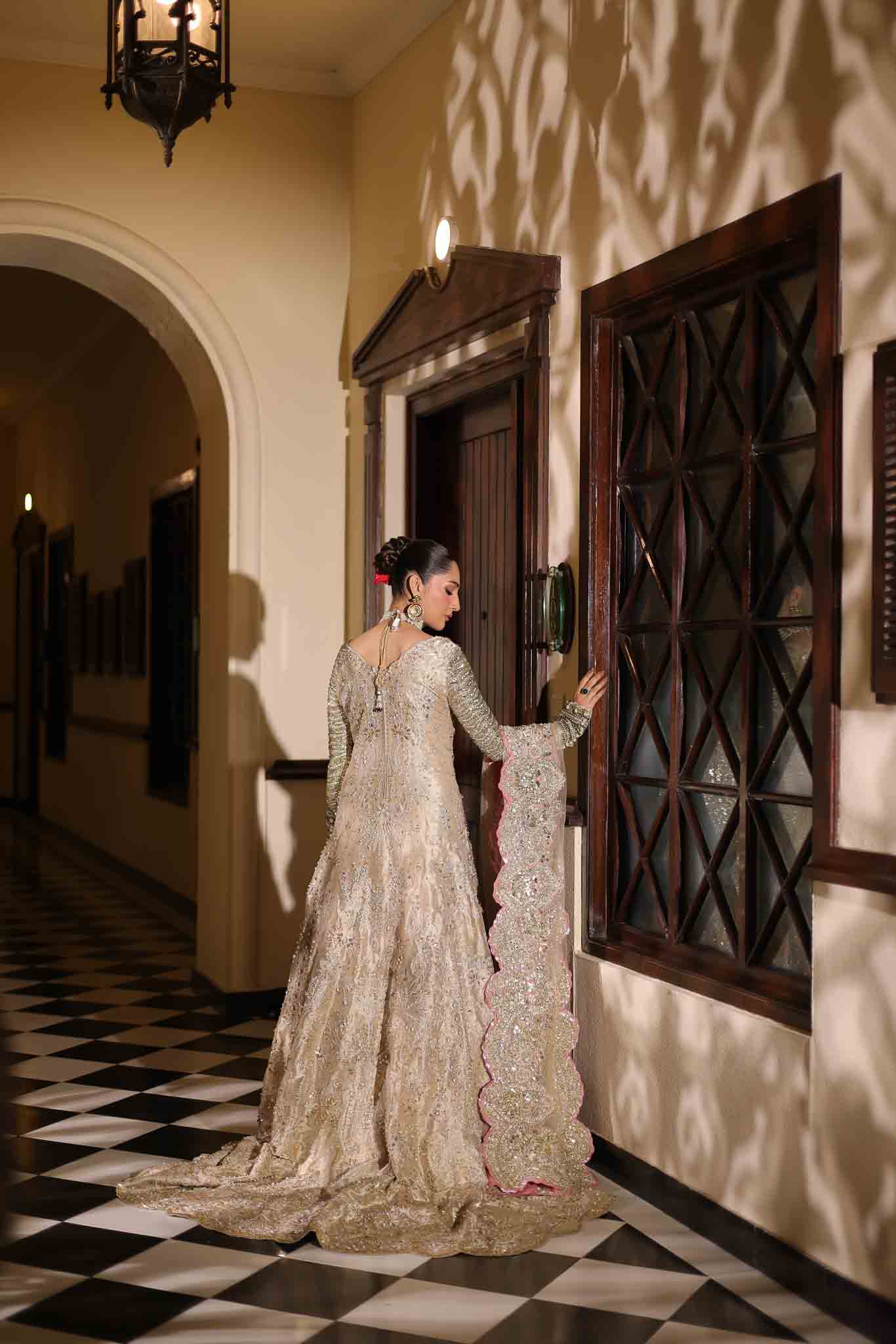Model wearing champagne gold dress LILA from Mysie by Tahira, intricately embellished Pakistani luxury pret available online in UK.