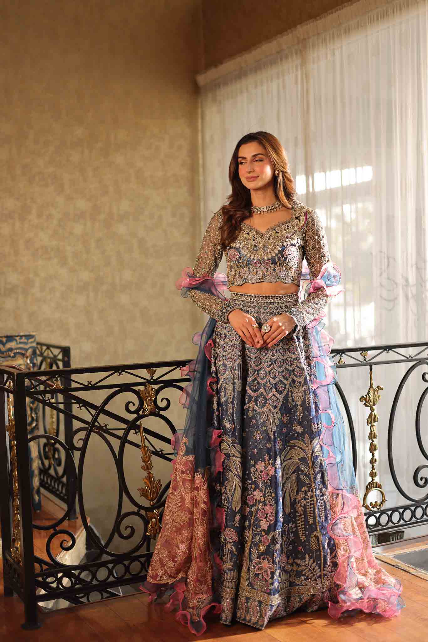 Model wearing blue and pink embellished lehenga choli Stella from Mysie By Tahira Wedding Edits '25, Pakistani luxury pret online in UK.