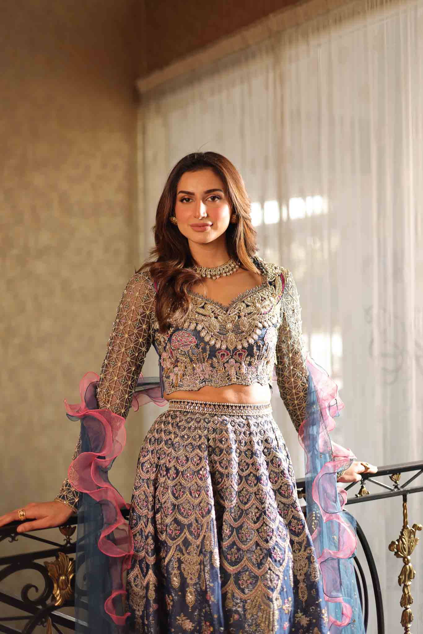 Model wearing blue and pink embellished lehenga choli Stella from Mysie By Tahira Wedding Edits '25, Pakistani luxury pret online in UK.