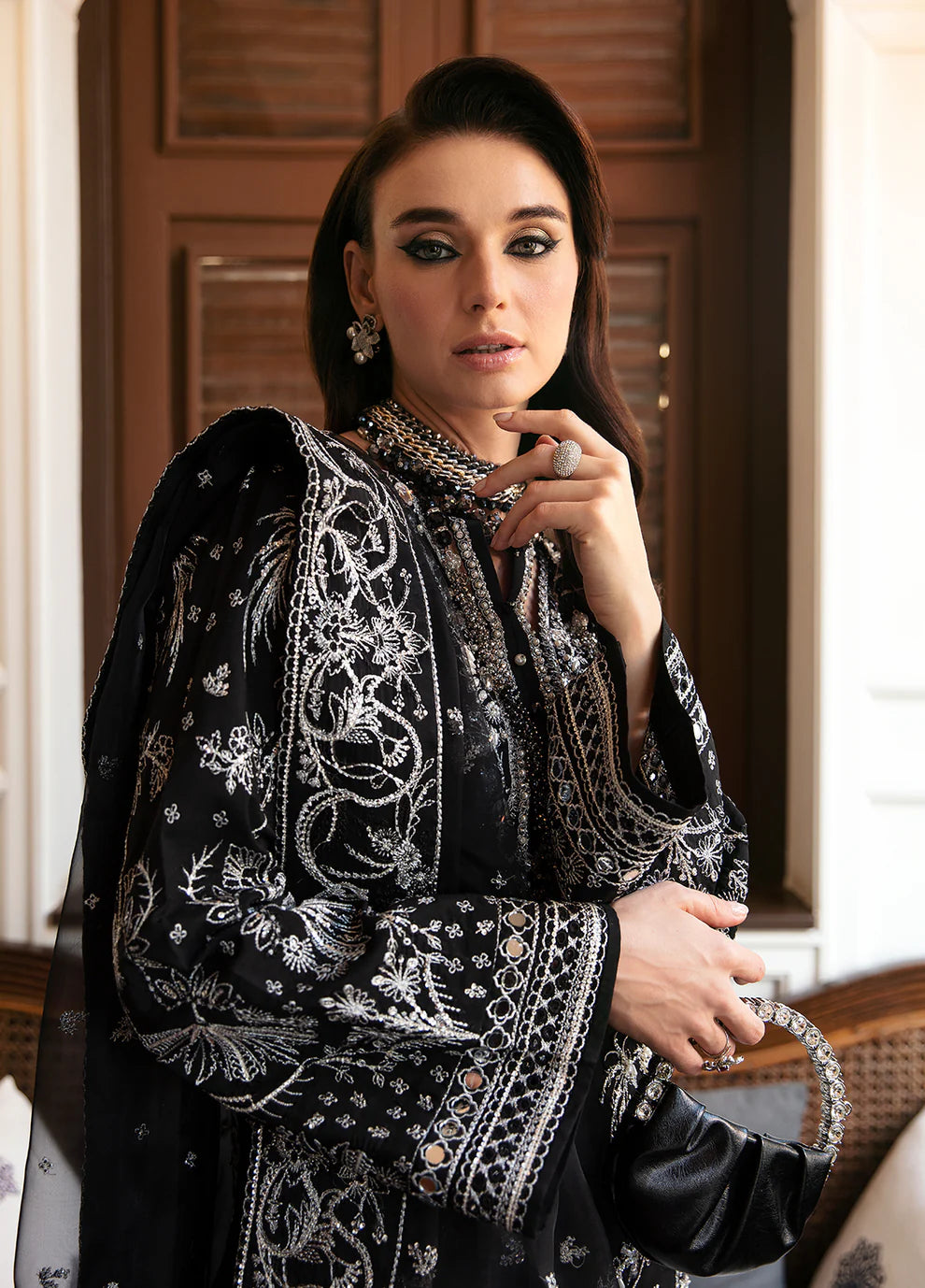 Model wearing Gulaal NADINE black embroidered outfit, UK Pakistani luxury attire.