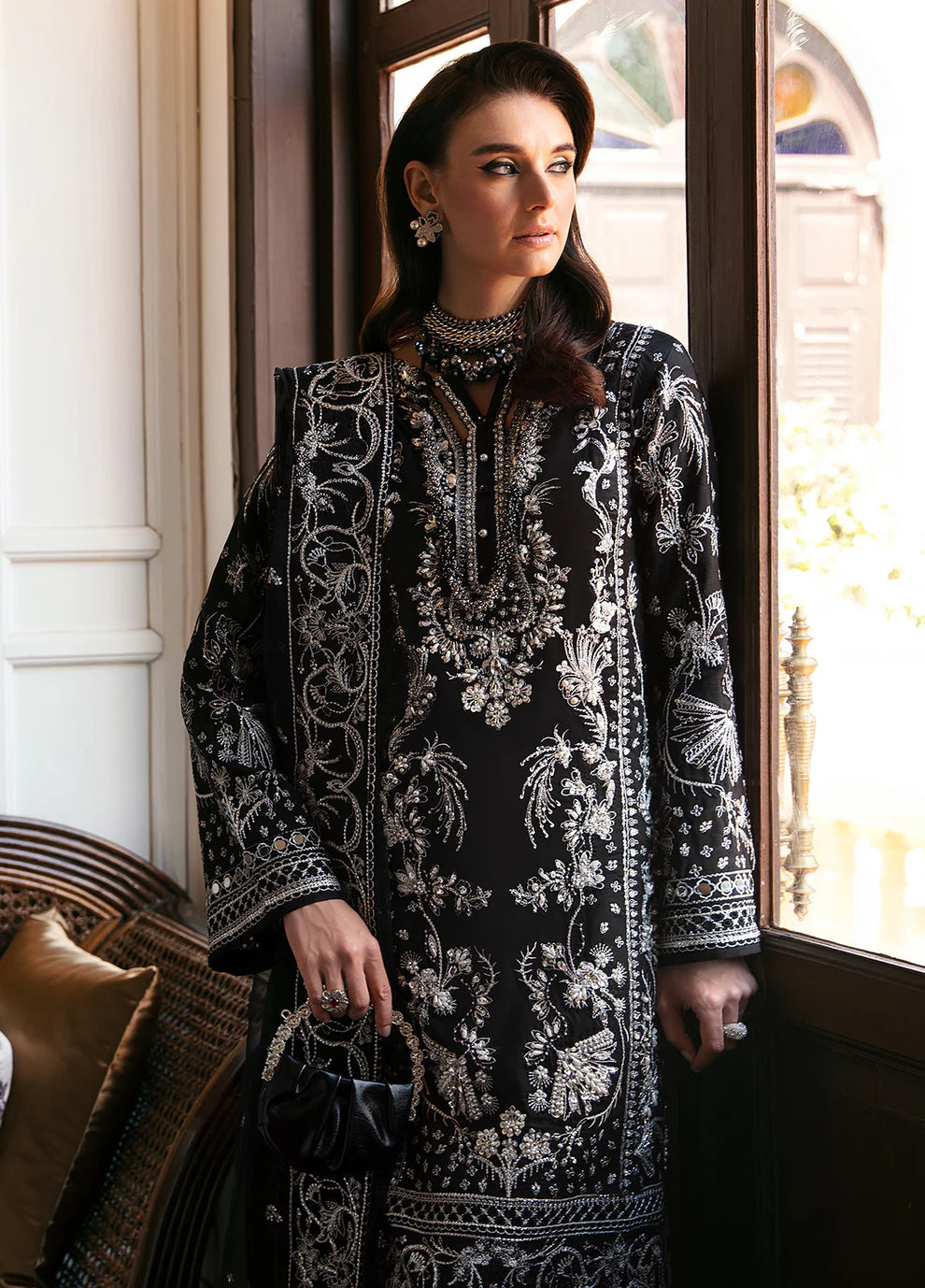 Model wearing Gulaal NADINE black embroidered outfit, UK Pakistani luxury attire.