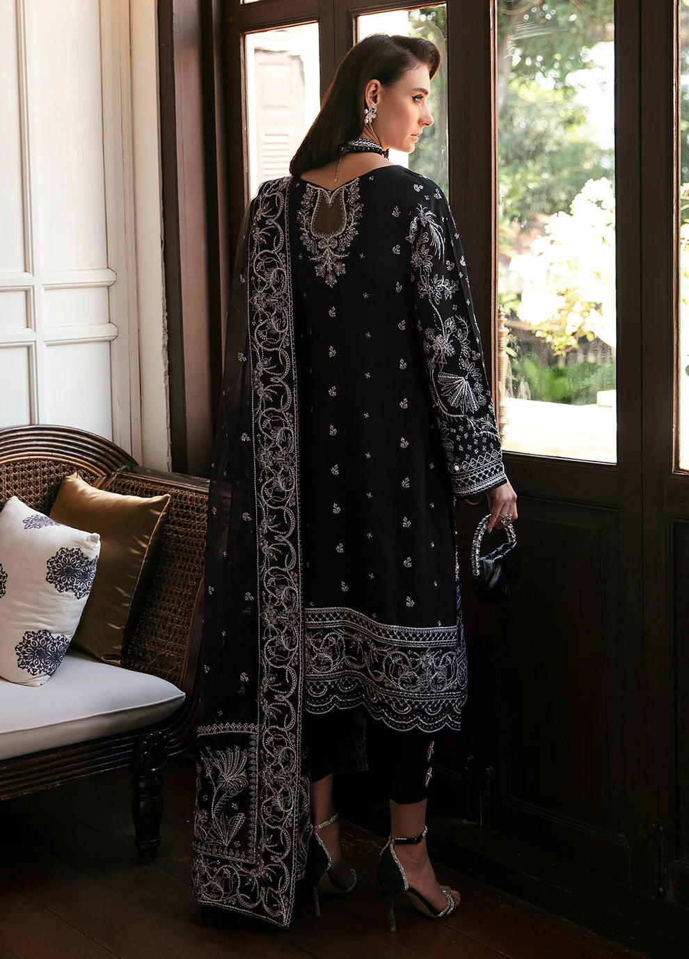 Model wearing Gulaal NADINE black embroidered outfit, UK Pakistani luxury attire.