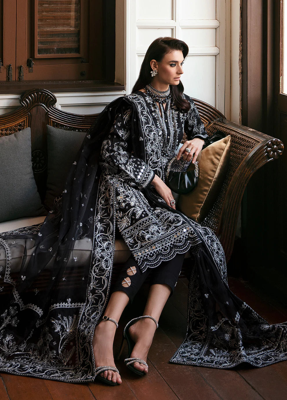Model wearing Gulaal NADINE black embroidered outfit, UK Pakistani luxury attire.