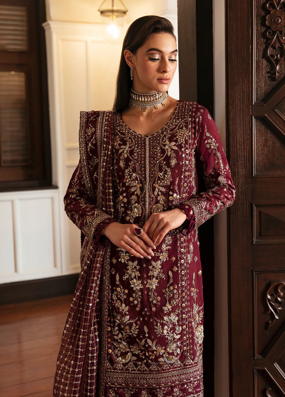 Model in Gulaal VALENTINA dress, maroon with gold embellishments, perfect for Pakistani clothes UK market.