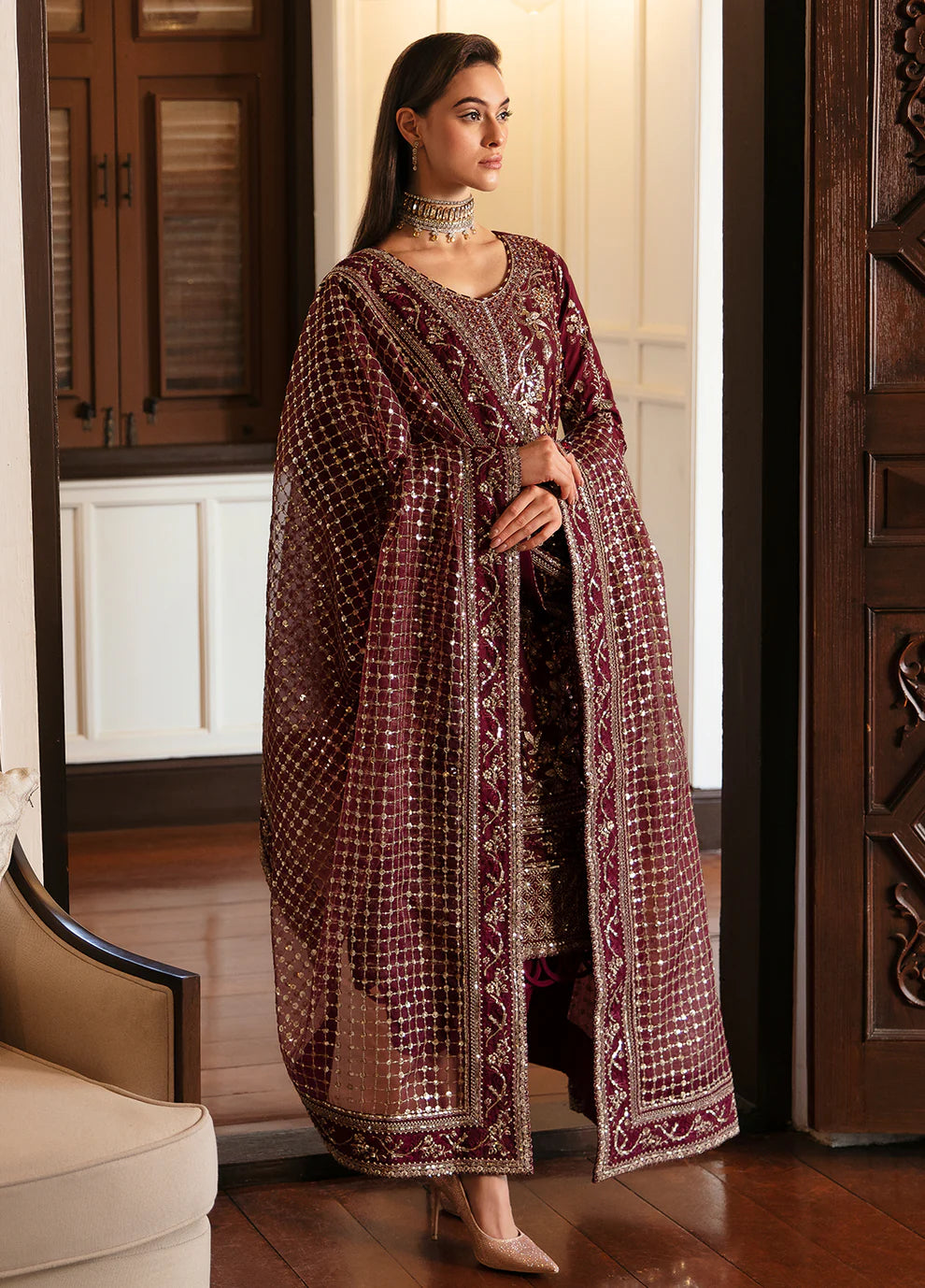 Model in Gulaal VALENTINA dress, maroon with gold embellishments, perfect for Pakistani clothes UK market.