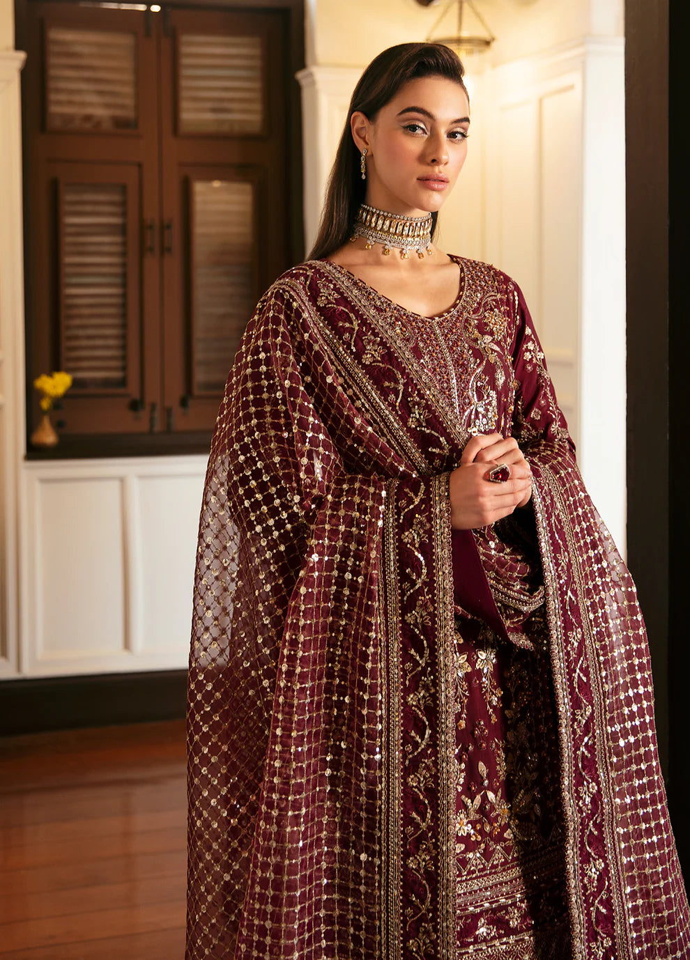Model in Gulaal VALENTINA dress, maroon with gold embellishments, perfect for Pakistani clothes UK market.