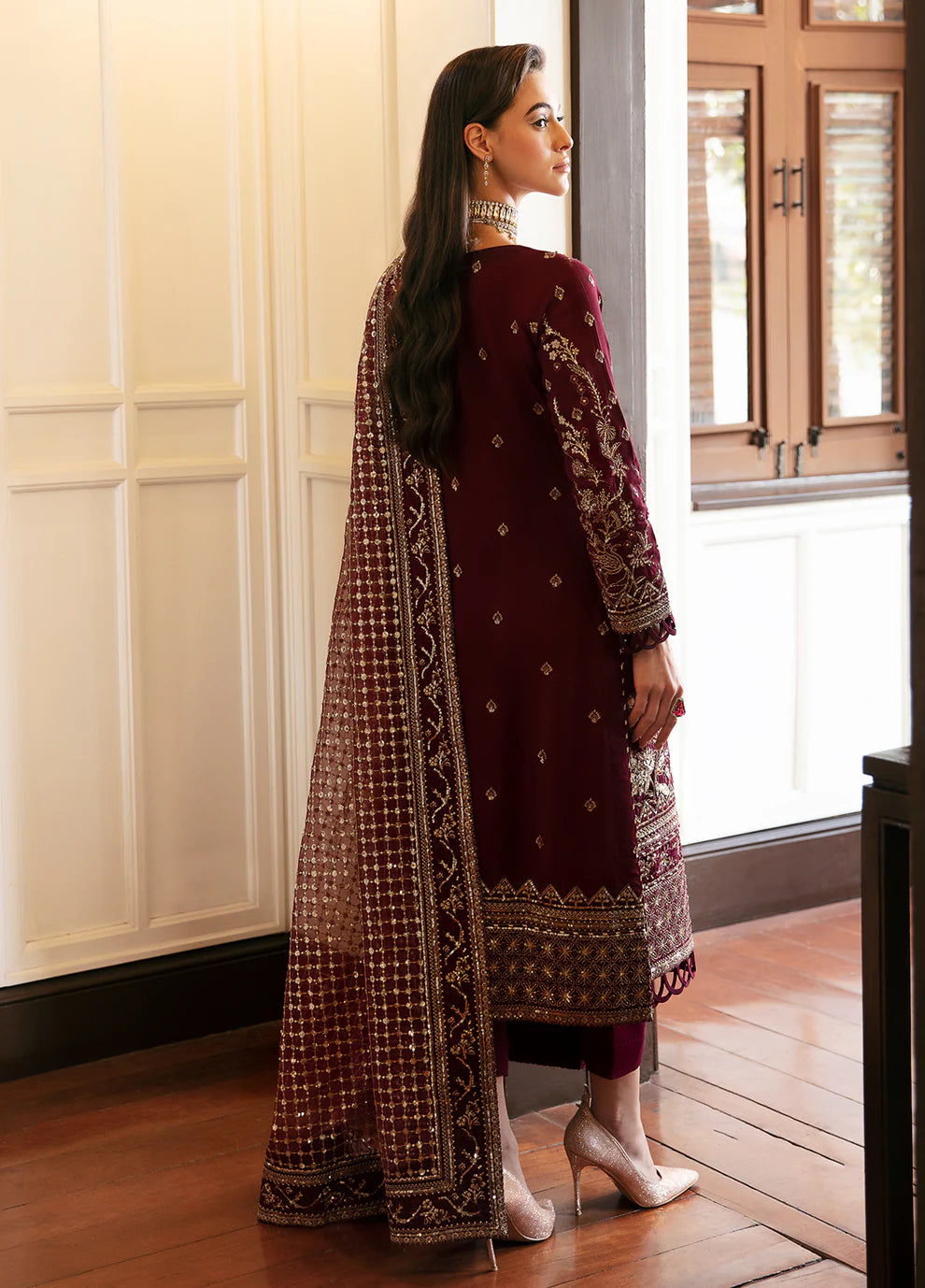 Model in Gulaal VALENTINA dress, maroon with gold embellishments, perfect for Pakistani clothes UK market.