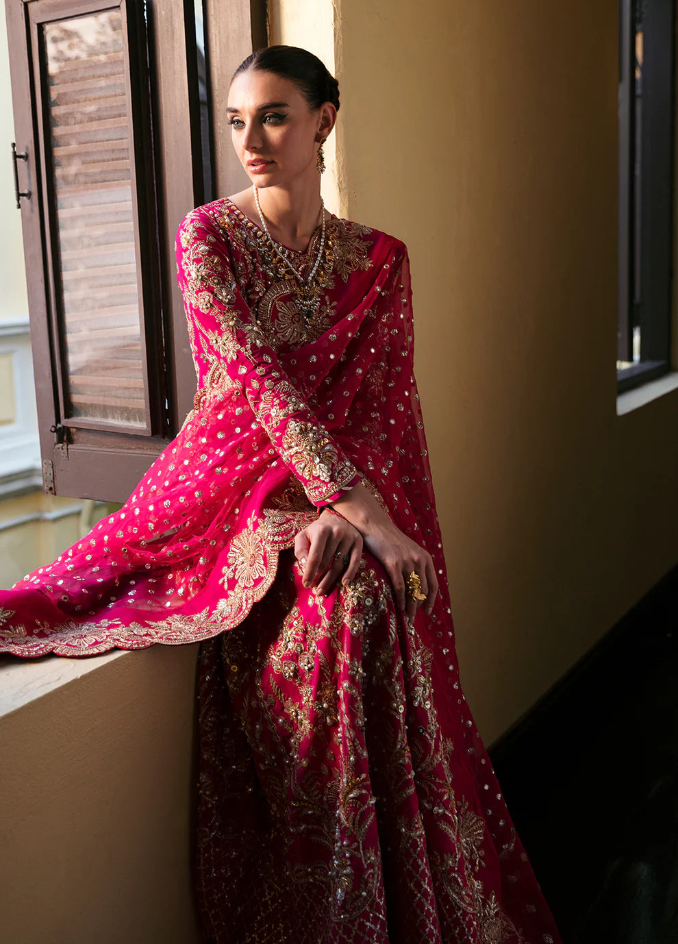 Model wearing Gulaal ROCHELLE pink embroidered dress, luxury Pakistani clothes UK.