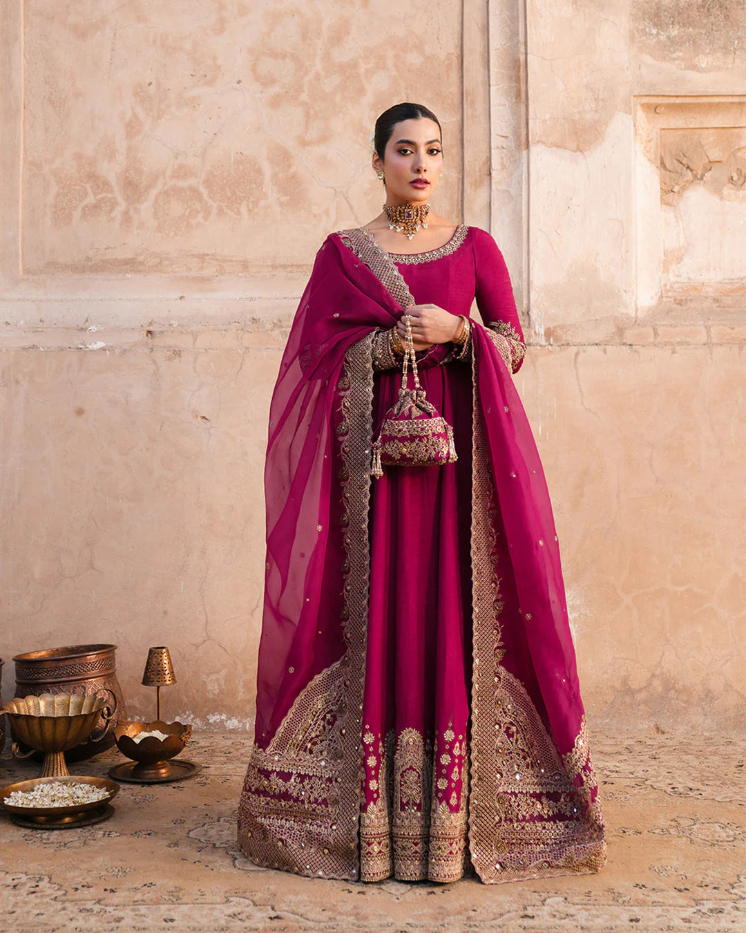 Model wearing deep burgundy pishwas with gold embroidery from Faiza Saqlain, Pakistani Luxury pret, Pakistani clothes online in UK.