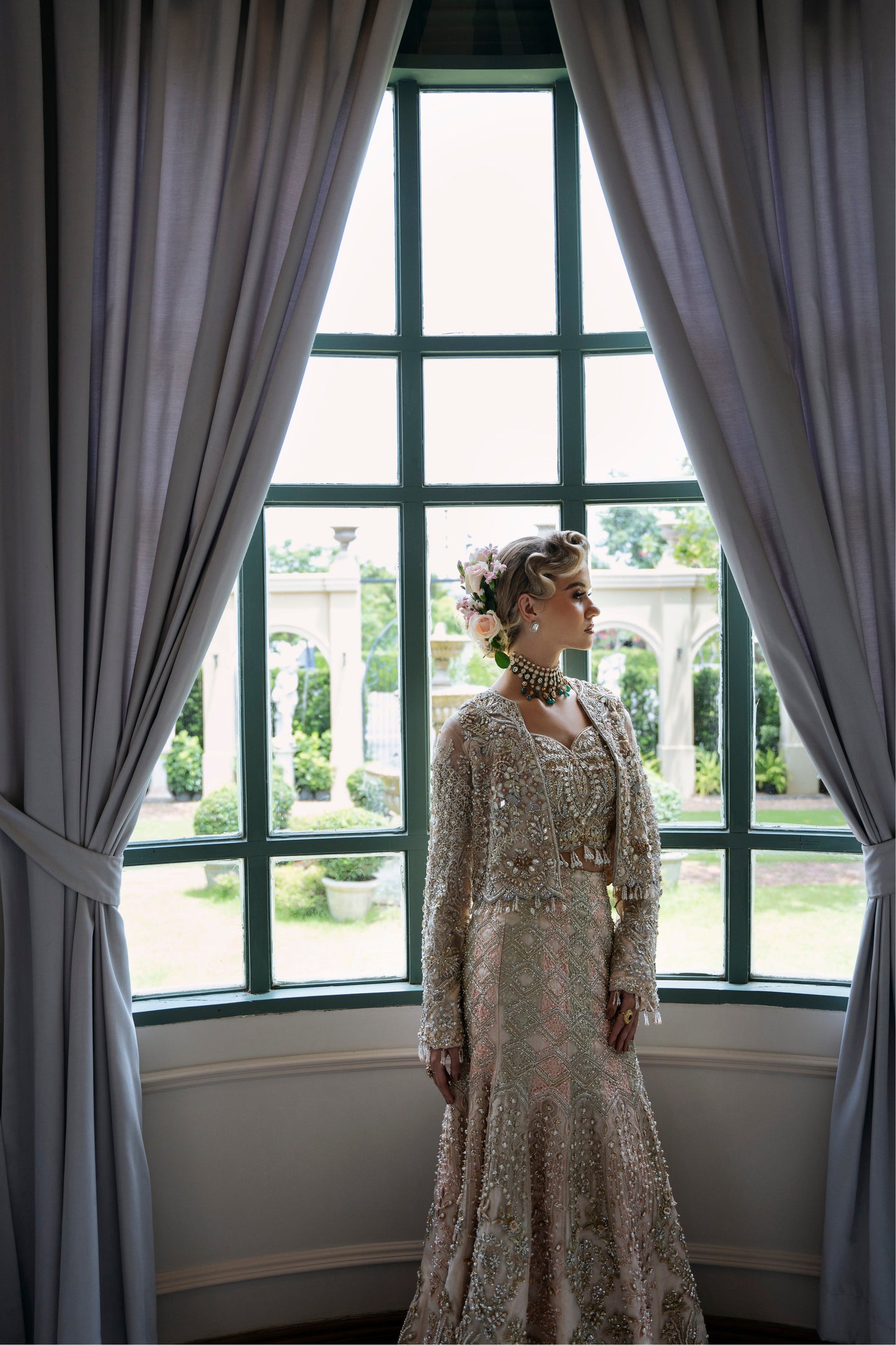 Model wearing soft pastel pink and gold embellished lehenga MALISA from Mysie by Tahira, Pakistani luxury pret available online in UK.