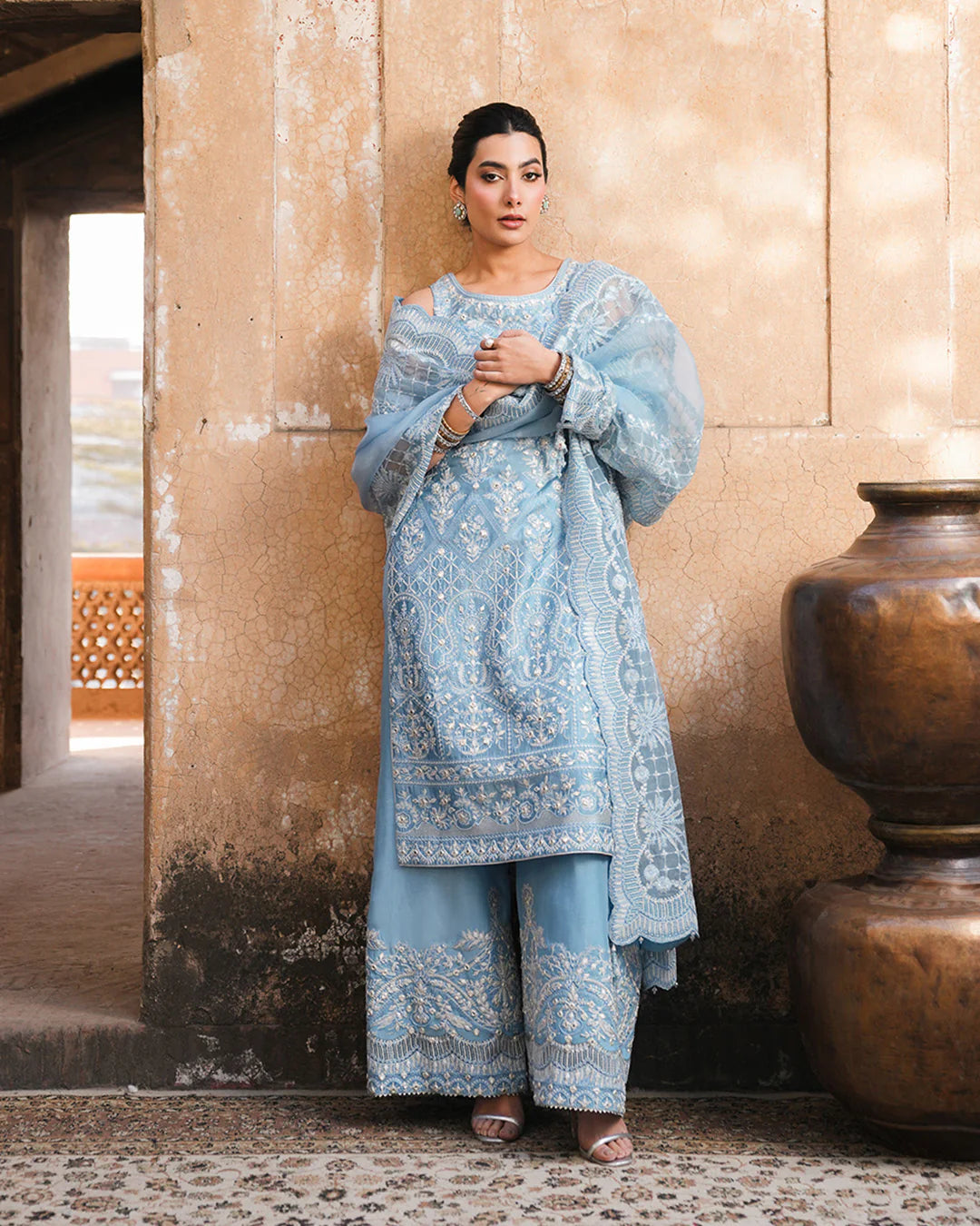 Model wearing powder blue Faiza Saqlain Yulia outfit with intricate embroidery and scalloped dupatta, ideal for Pakistani luxury pret in UK.