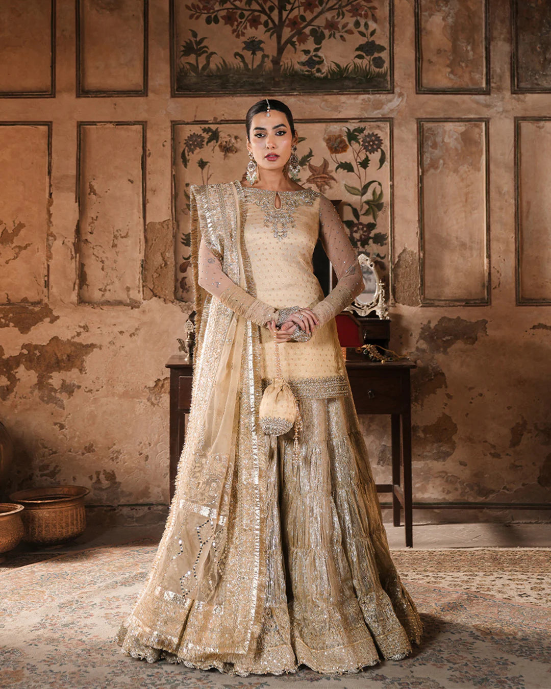 Model wearing gold Faiza Saqlain Camillie outfit with heavy embellishment, perfect for Pakistani luxury pret and festive wear in the UK.