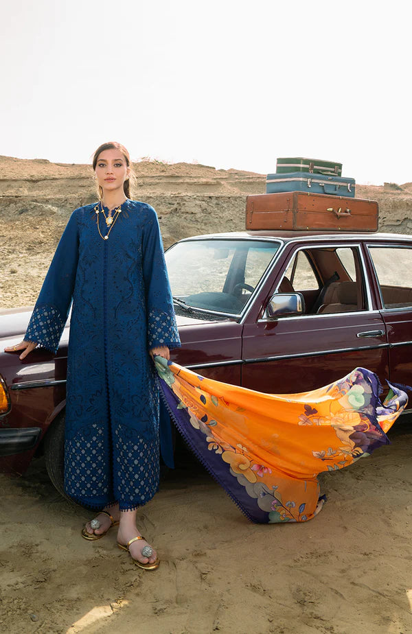 Model wearing royal blue embroidered dress with floral dupatta from Soraya Noa Summer Casual Pret 2025 Azul. Pakistani luxury pret in UK.