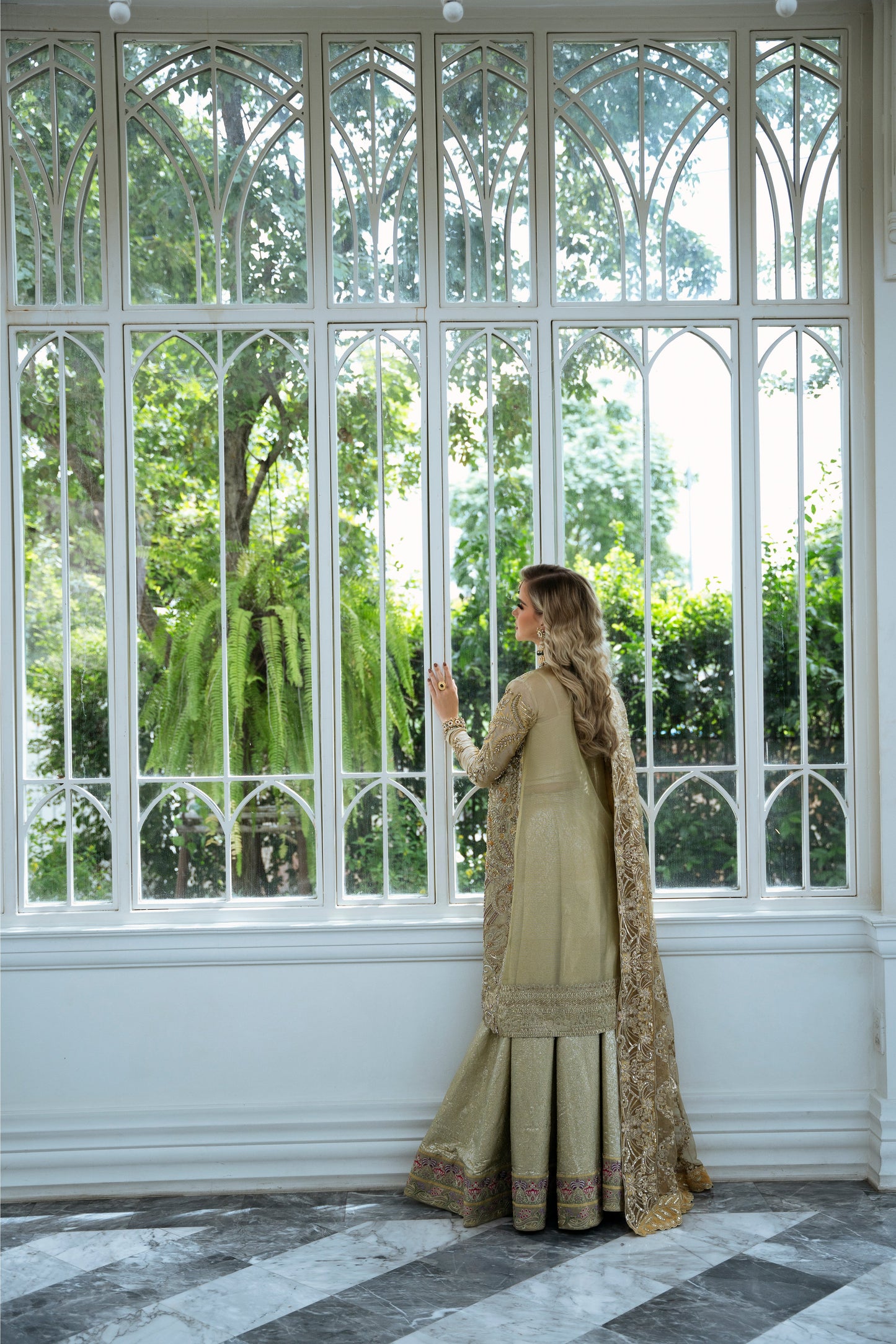 Model wearing Marigold from Mysie by Tahira, a golden-hued ensemble with intricate embroidery, ideal for Pakistani luxury pret in the UK.