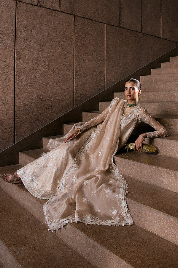 Model wearing beige embellished ensemble from Suffuse Ismira, Pakistani luxury pret, shop Pakistani clothes online in UK