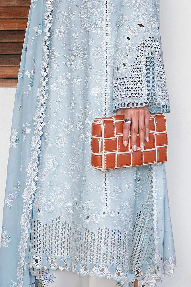 Model wearing pastel blue embroidered dress from Suffuse Casual Pret 2025 Zarina. Pakistani luxury pret and Pakistani clothes online in UK.