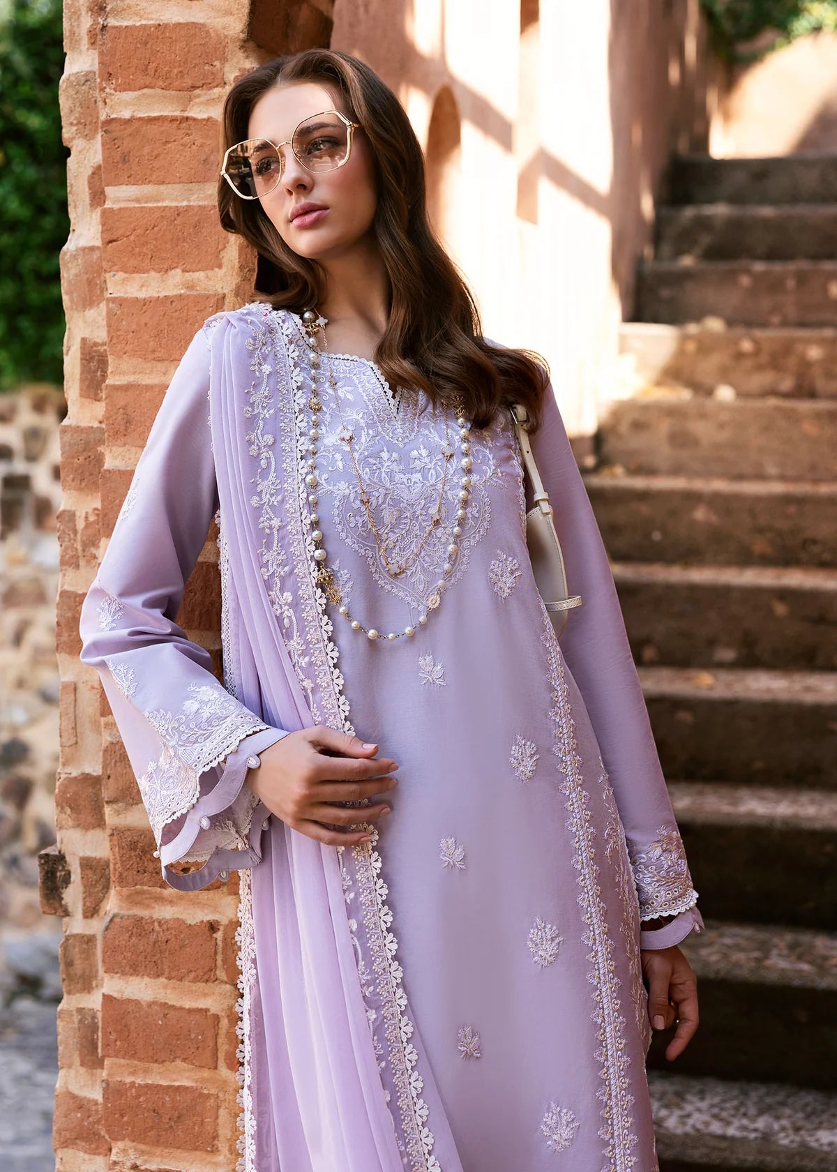 Model wearing Kanwal Malik Siena KM Basics '25 Zoe in soft lilac with delicate embroidery. Shop Pakistani luxury pret online in the UK.
