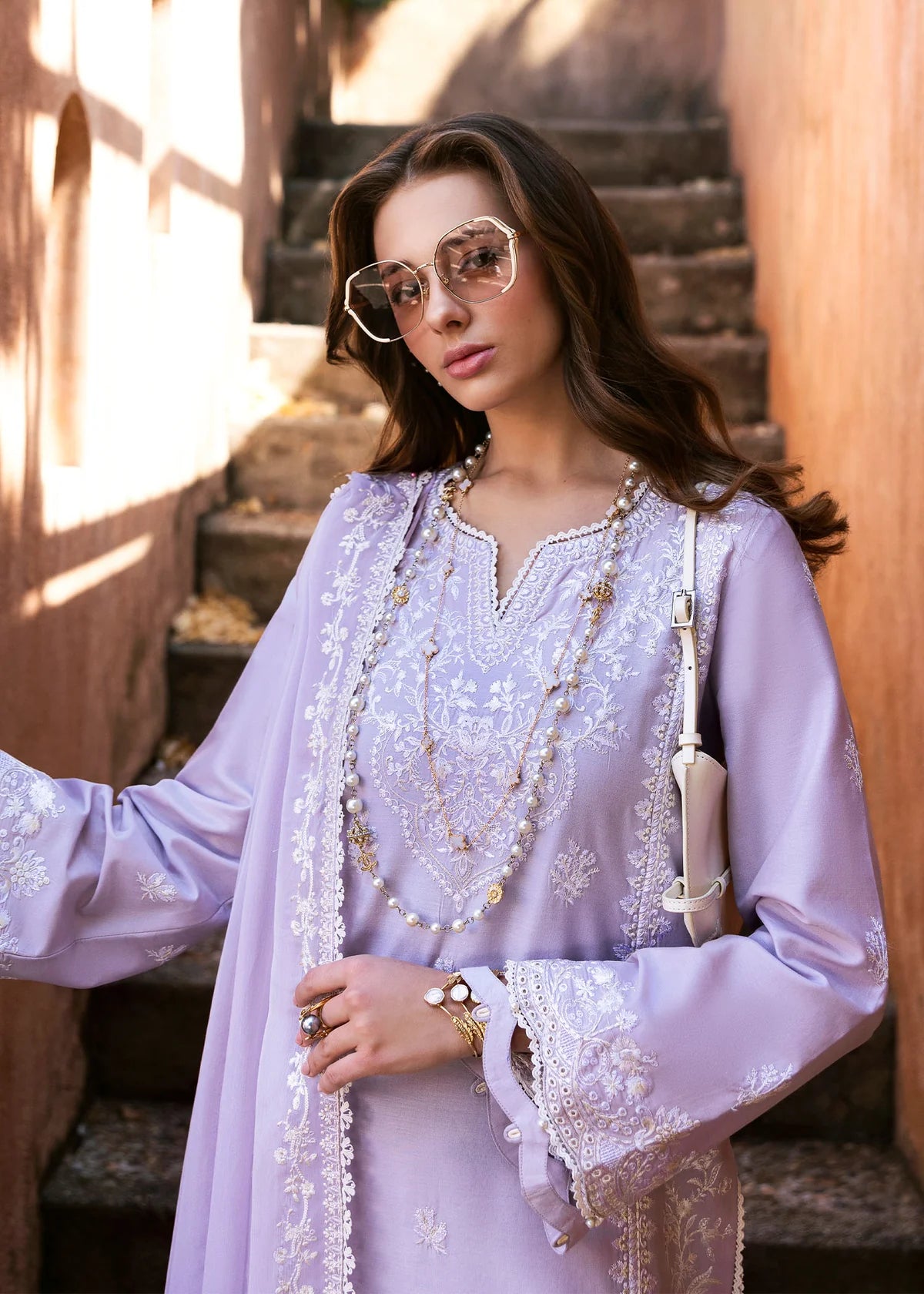 Model wearing Kanwal Malik Siena KM Basics '25 Zoe in soft lilac with delicate embroidery. Shop Pakistani luxury pret online in the UK.
