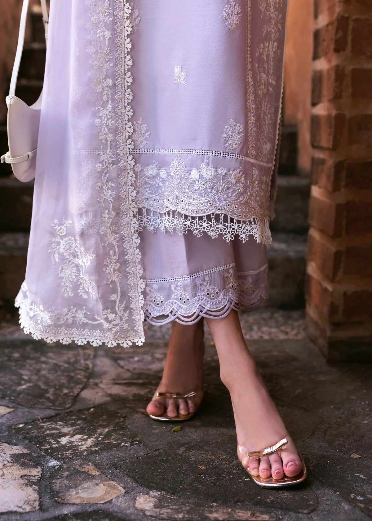 Model wearing Kanwal Malik Siena KM Basics '25 Zoe in soft lilac with delicate embroidery. Shop Pakistani luxury pret online in the UK.