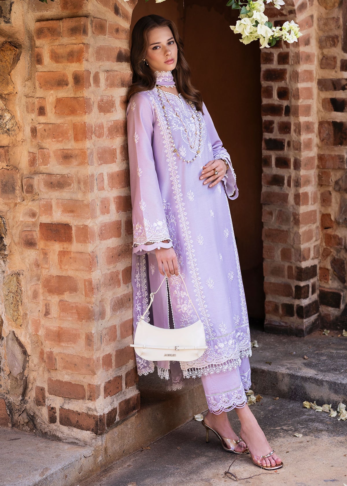 Model wearing Kanwal Malik Siena KM Basics '25 Zoe in soft lilac with delicate embroidery. Shop Pakistani luxury pret online in the UK.