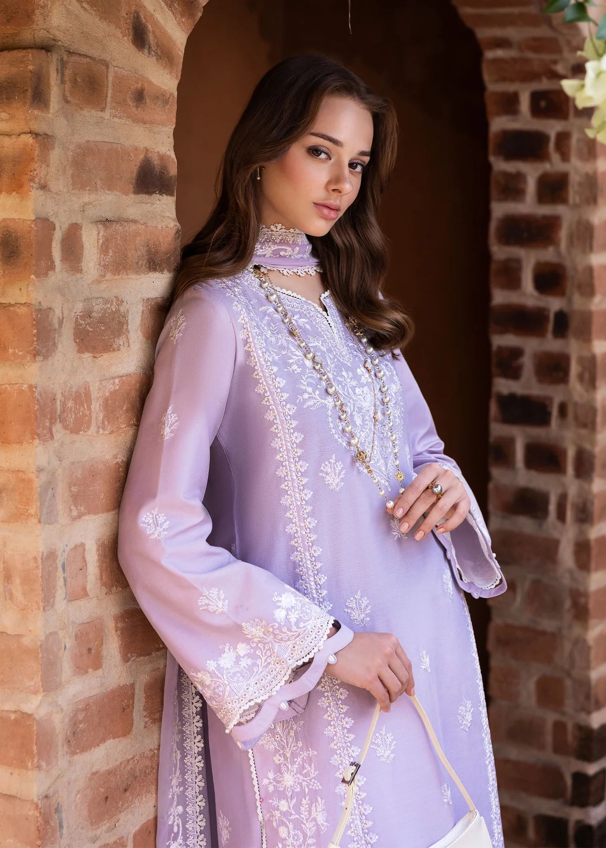 Model wearing Kanwal Malik Siena KM Basics '25 Zoe in soft lilac with delicate embroidery. Shop Pakistani luxury pret online in the UK.