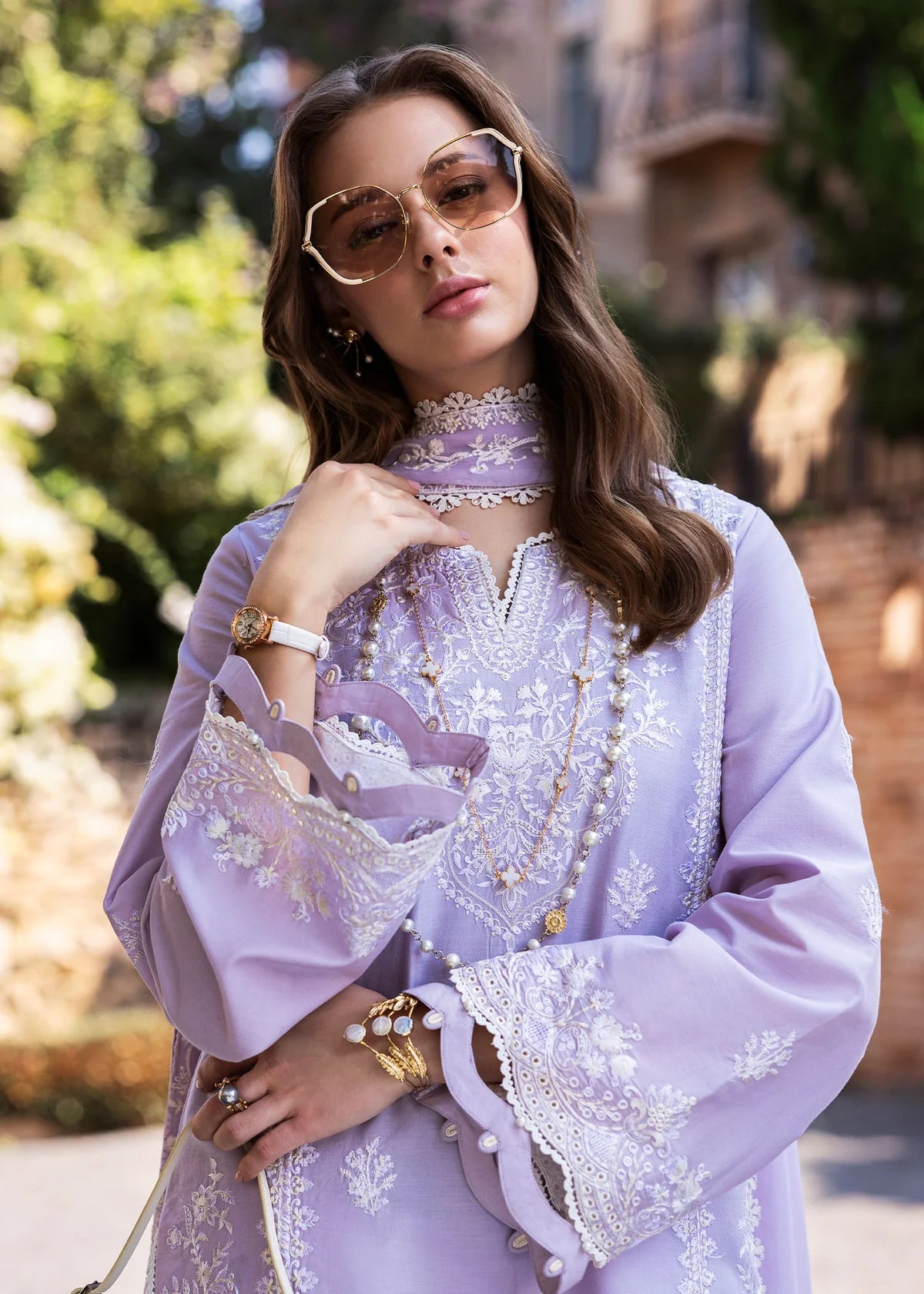 Model wearing Kanwal Malik Siena KM Basics '25 Zoe in soft lilac with delicate embroidery. Shop Pakistani luxury pret online in the UK.