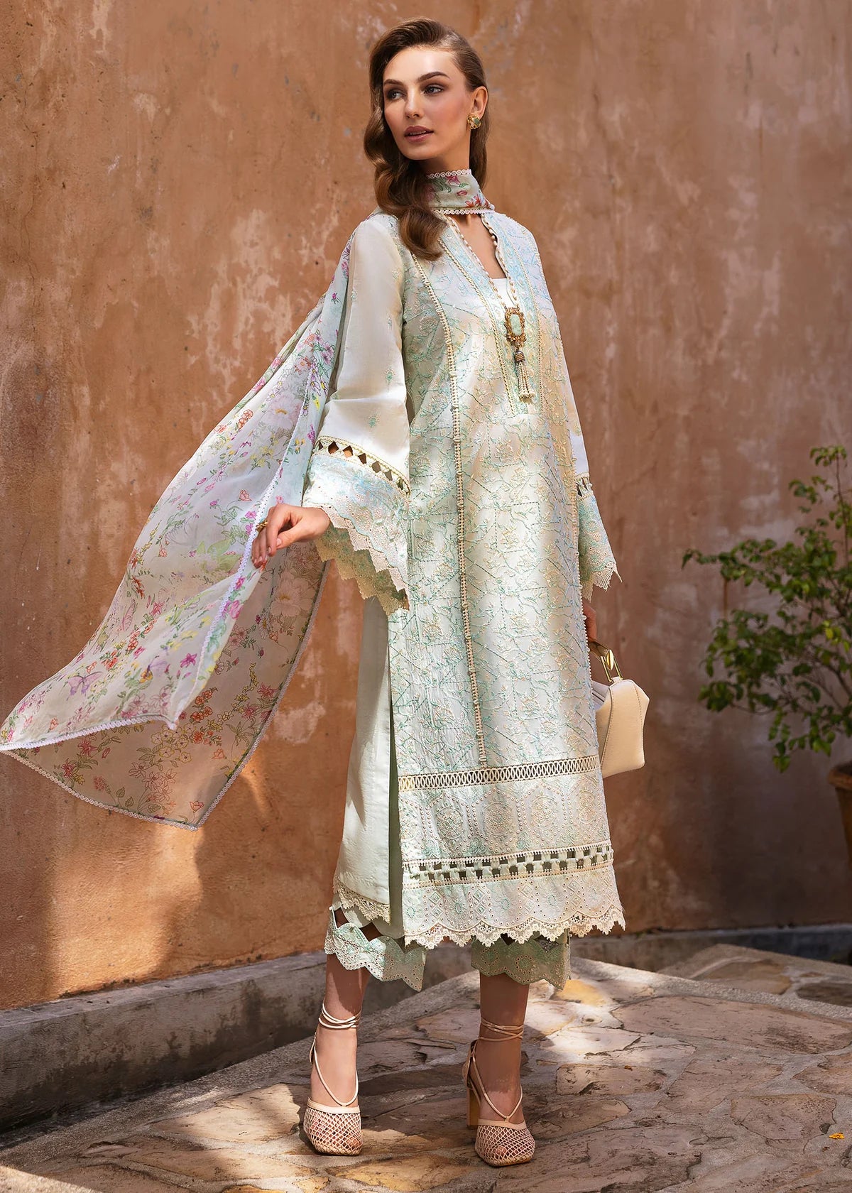 Model wearing Kanwal Malik Siena KM Basics '25 Mirel in pastel mint with floral embroidery. Shop Pakistani luxury pret online in the UK.