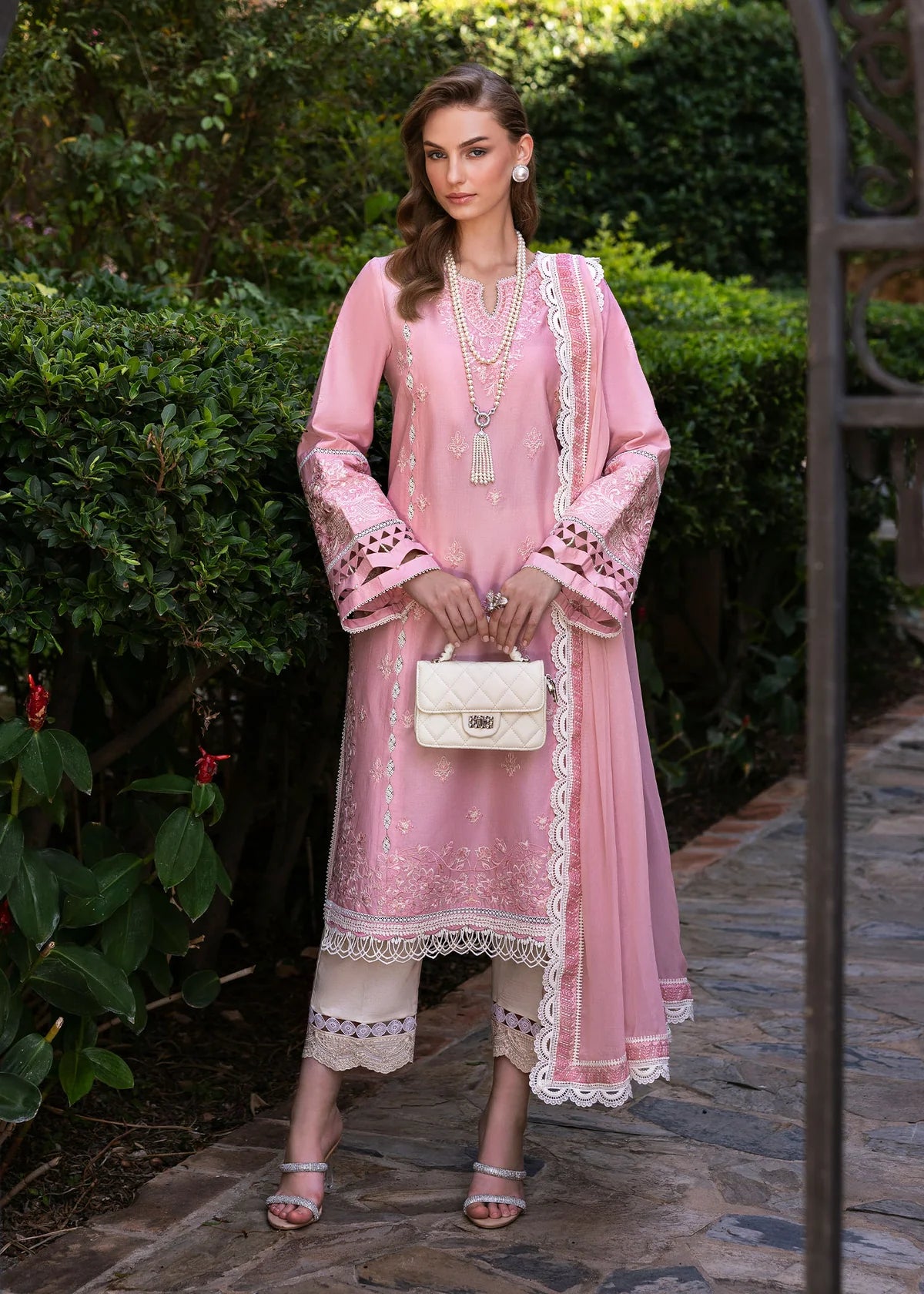 Model wearing Kanwal Malik Siena KM Basics '25 Flora in soft pink with delicate embroidery. Shop Pakistani luxury pret online in the UK.