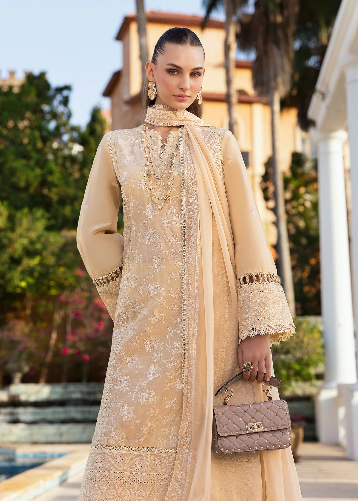 Model wearing Kanwal Malik Siena KM Basics '25 Sage in pastel beige with delicate embroidery. Shop Pakistani luxury pret online in the UK.