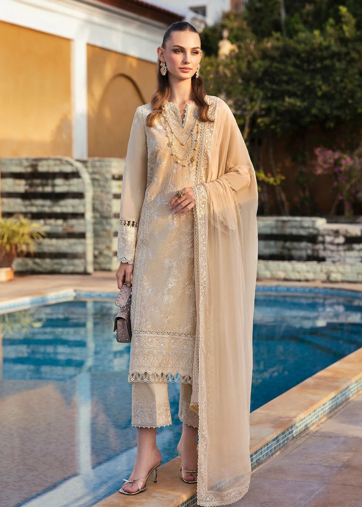 Model wearing Kanwal Malik Siena KM Basics '25 Sage in pastel beige with delicate embroidery. Shop Pakistani luxury pret online in the UK.