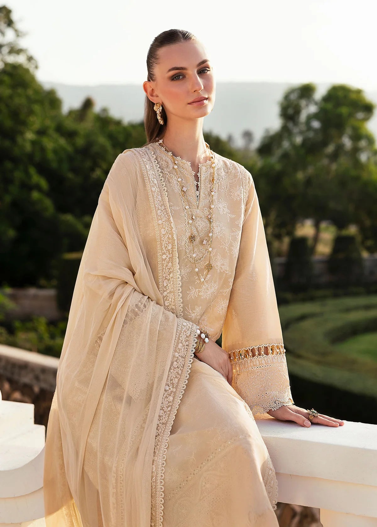 Model wearing Kanwal Malik Siena KM Basics '25 Sage in pastel beige with delicate embroidery. Shop Pakistani luxury pret online in the UK.