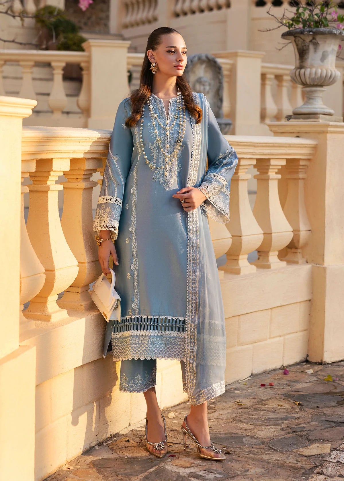 Model wearing Kanwal Malik Siena KM Basics '25 Kiara in pastel blue with delicate embroidery. Shop Pakistani luxury pret online in the UK.