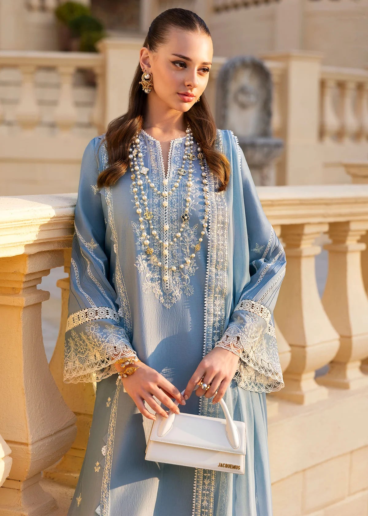 Model wearing Kanwal Malik Siena KM Basics '25 Kiara in pastel blue with delicate embroidery. Shop Pakistani luxury pret online in the UK.