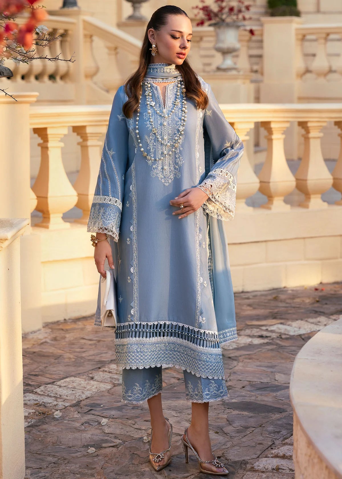 Model wearing Kanwal Malik Siena KM Basics '25 Kiara in pastel blue with delicate embroidery. Shop Pakistani luxury pret online in the UK.