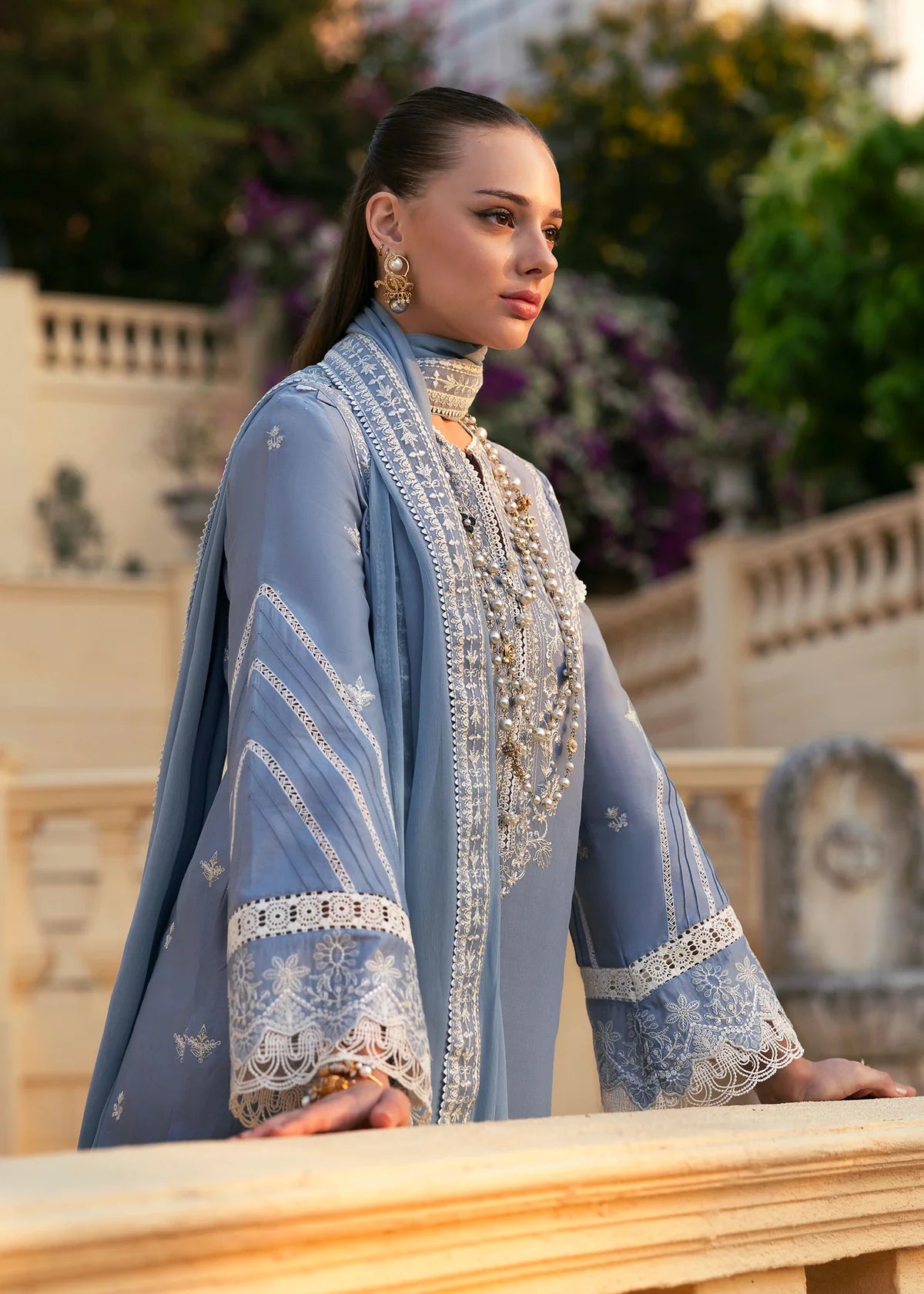 Model wearing Kanwal Malik Siena KM Basics '25 Kiara in pastel blue with delicate embroidery. Shop Pakistani luxury pret online in the UK.