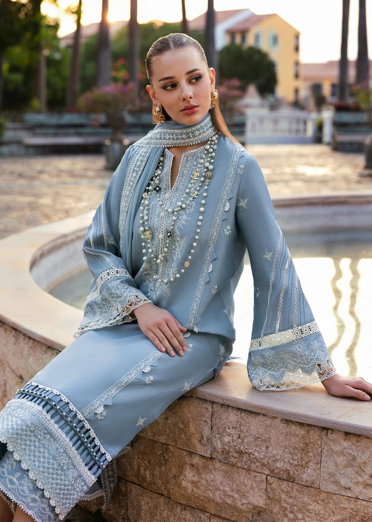Model wearing Kanwal Malik Siena KM Basics '25 Kiara in pastel blue with delicate embroidery. Shop Pakistani luxury pret online in the UK.