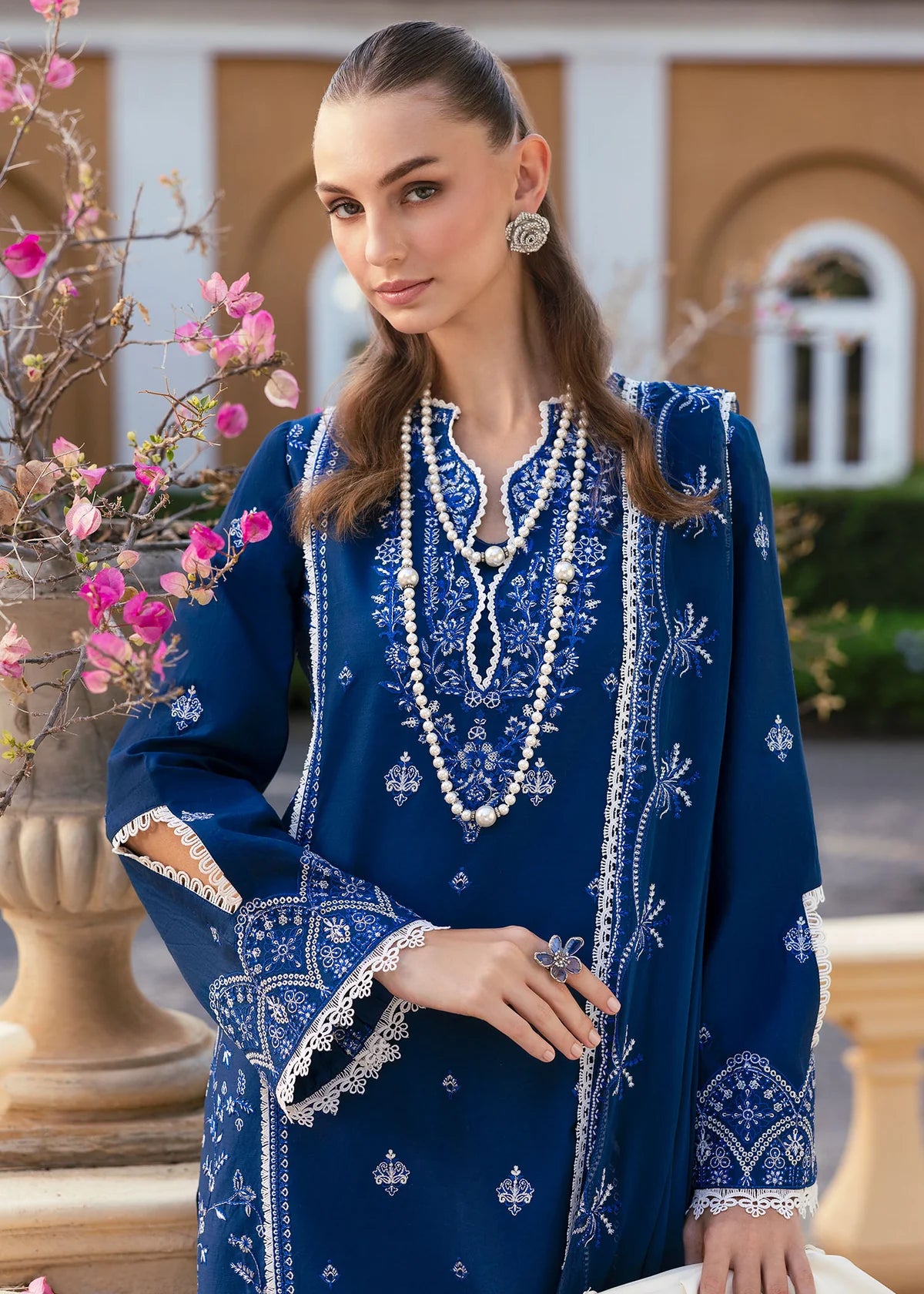 Model wearing Kanwal Malik Siena KM Basics '25 Zuha in navy blue with intricate embroidery. Shop Pakistani luxury pret online in the UK.