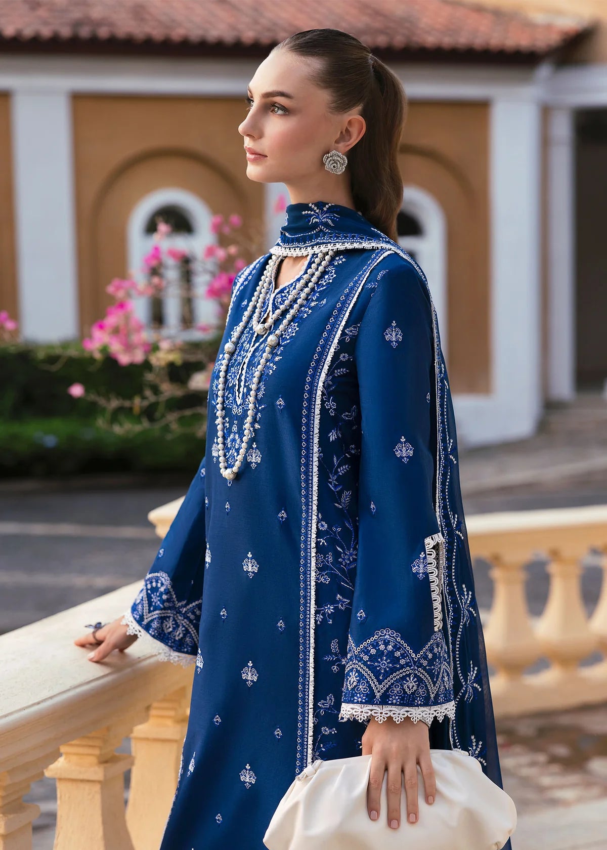 Model wearing Kanwal Malik Siena KM Basics '25 Zuha in navy blue with intricate embroidery. Shop Pakistani luxury pret online in the UK.