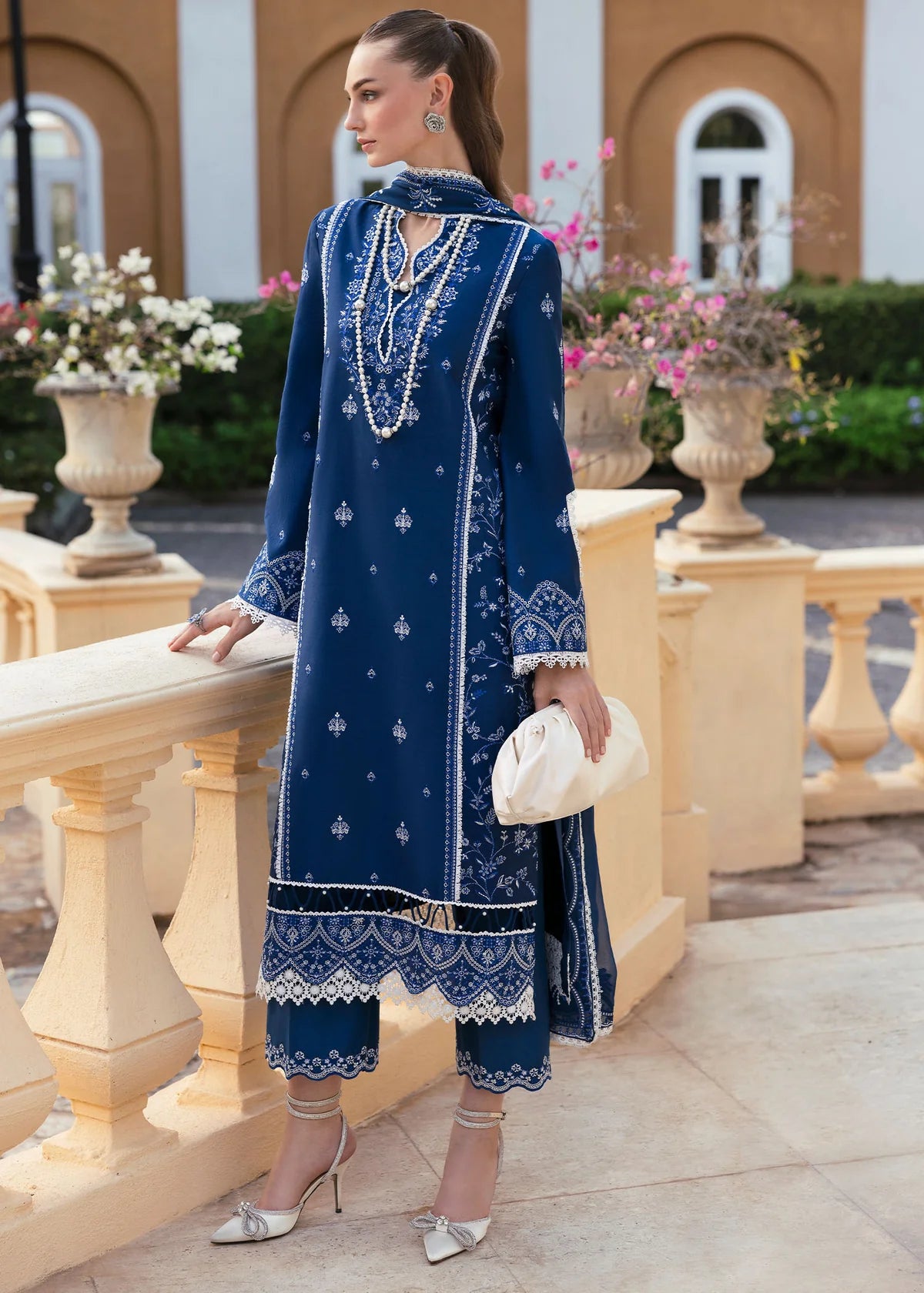 Model wearing Kanwal Malik Siena KM Basics '25 Zuha in navy blue with intricate embroidery. Shop Pakistani luxury pret online in the UK.