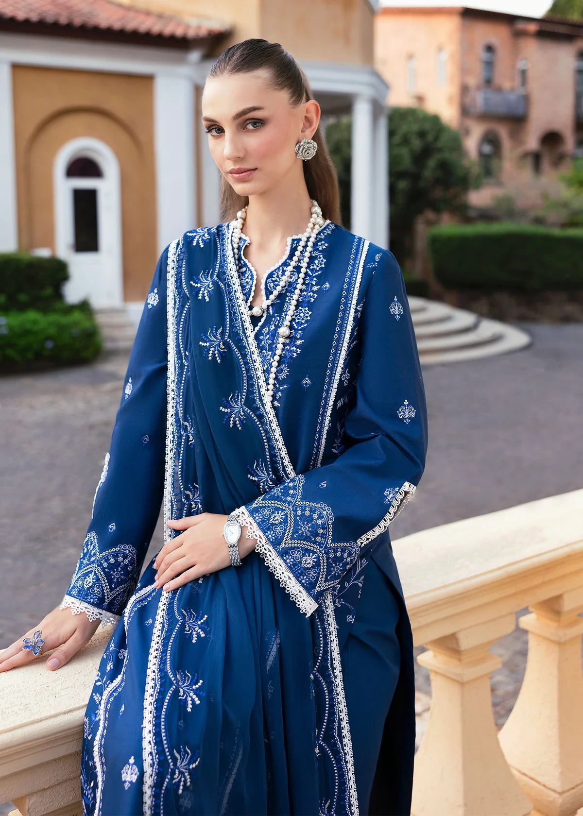 Model wearing Kanwal Malik Siena KM Basics '25 Zuha in navy blue with intricate embroidery. Shop Pakistani luxury pret online in the UK.