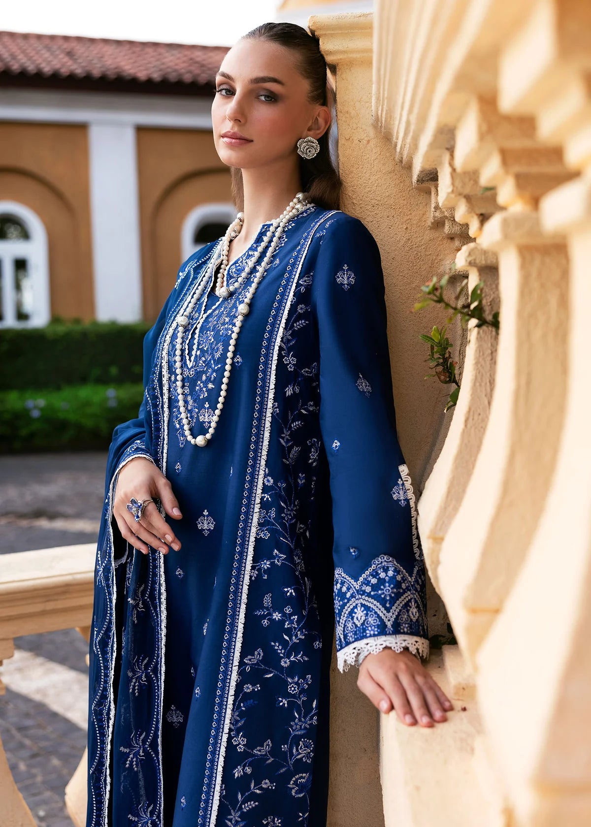 Model wearing Kanwal Malik Siena KM Basics '25 Zuha in navy blue with intricate embroidery. Shop Pakistani luxury pret online in the UK.
