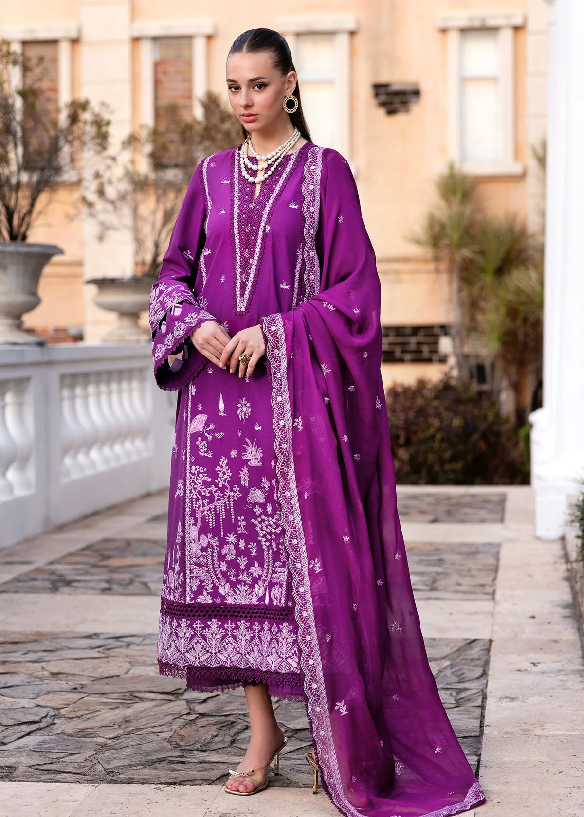 Model wearing Kanwal Malik Siena KM Basics '25 Cyra in purple with intricate embroidery. Shop Pakistani luxury pret online in the UK.