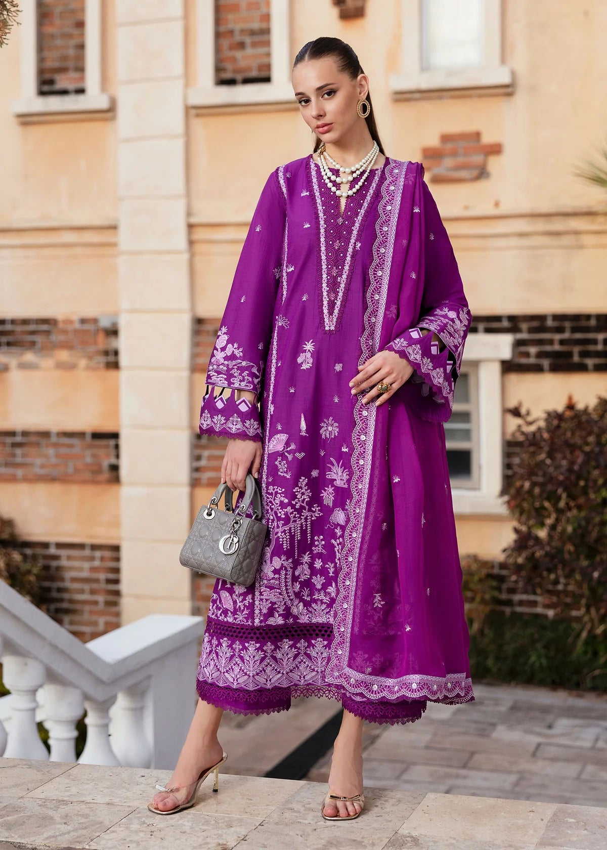 Model wearing Kanwal Malik Siena KM Basics '25 Cyra in purple with intricate embroidery. Shop Pakistani luxury pret online in the UK.