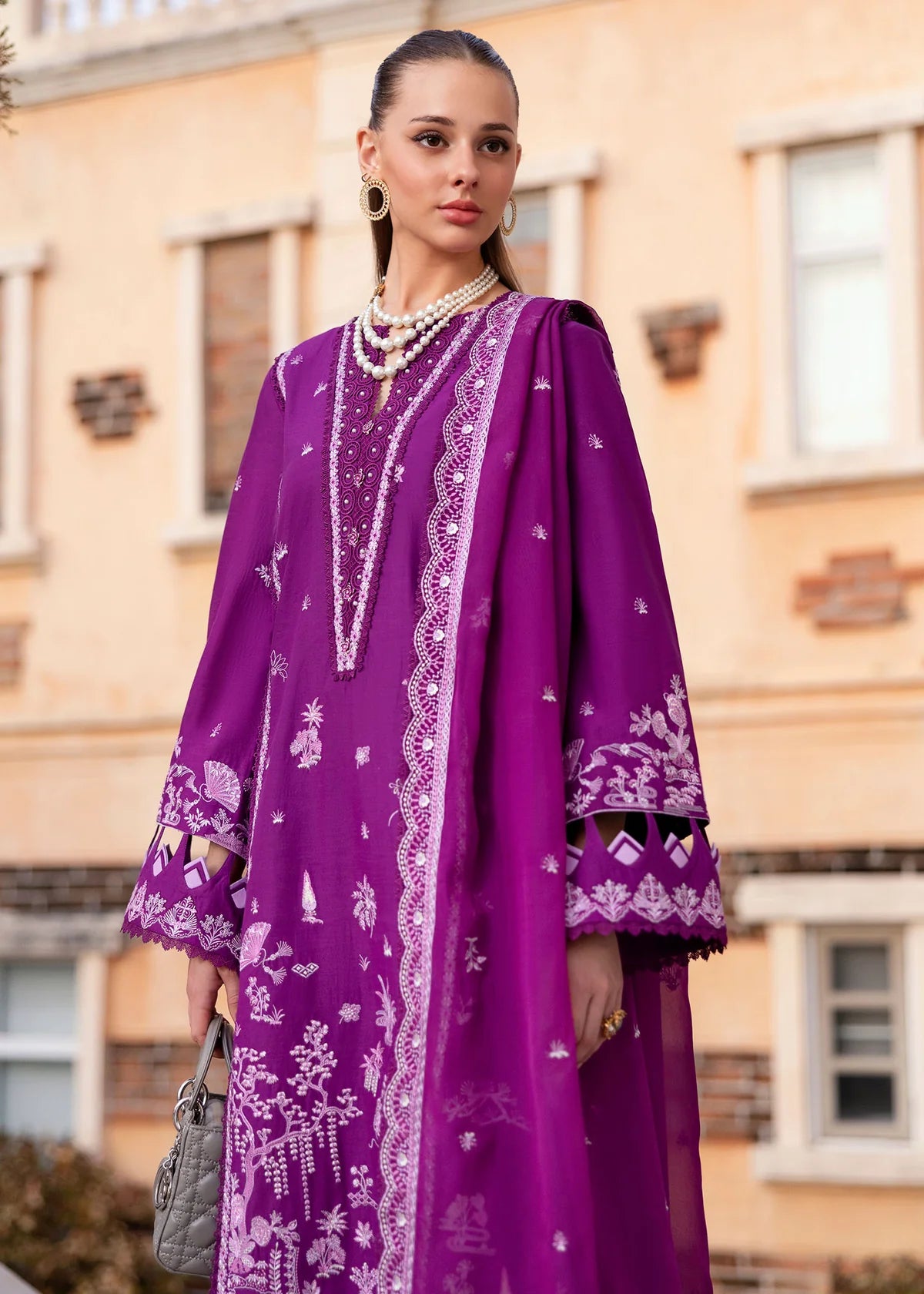Model wearing Kanwal Malik Siena KM Basics '25 Cyra in purple with intricate embroidery. Shop Pakistani luxury pret online in the UK.