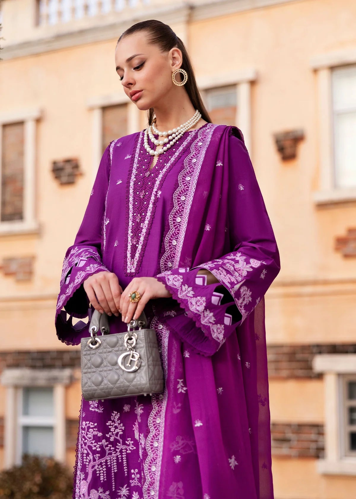 Model wearing Kanwal Malik Siena KM Basics '25 Cyra in purple with intricate embroidery. Shop Pakistani luxury pret online in the UK.