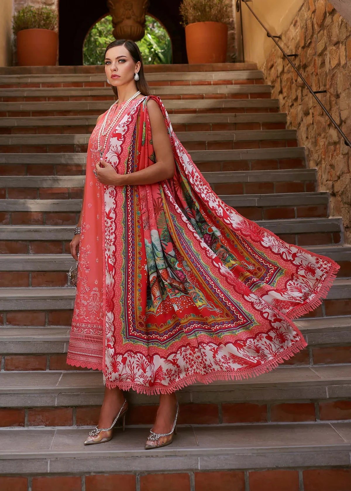 Model wearing coral red Aanya dress from Kanwal Malik Zaina Lawn '25, perfect for Pakistani luxury pret and Pakistani clothes online in UK.