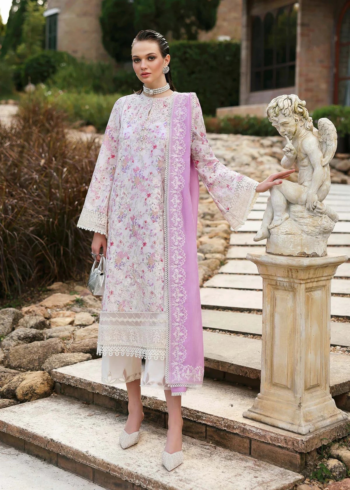 Model wearing pastel pink and white floral Raya dress from Kanwal Malik Zaina Lawn '25, Pakistani luxury pret for online shoppers in UK.